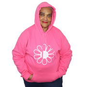 Woman wearing a bright pink hoodie with a white flower design on a white background