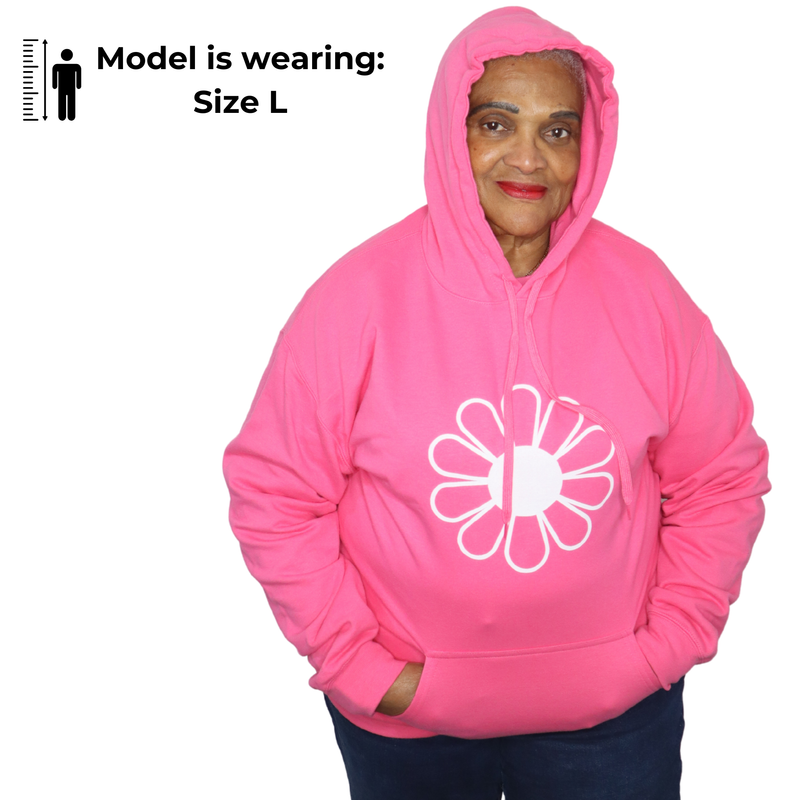 Woman wearing a pink hoodie with a white flower design on a white background