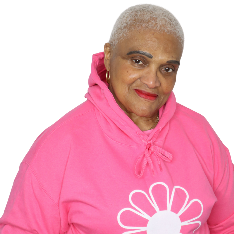 Woman wearing a pink hoodie with a white flower design on a white background