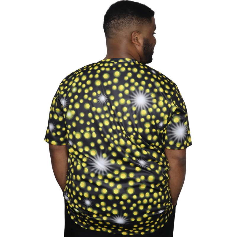 Model shown with hand on hip, wearing a sports jersey featuring an all over scattered light and firefly glow pattern in ye...
