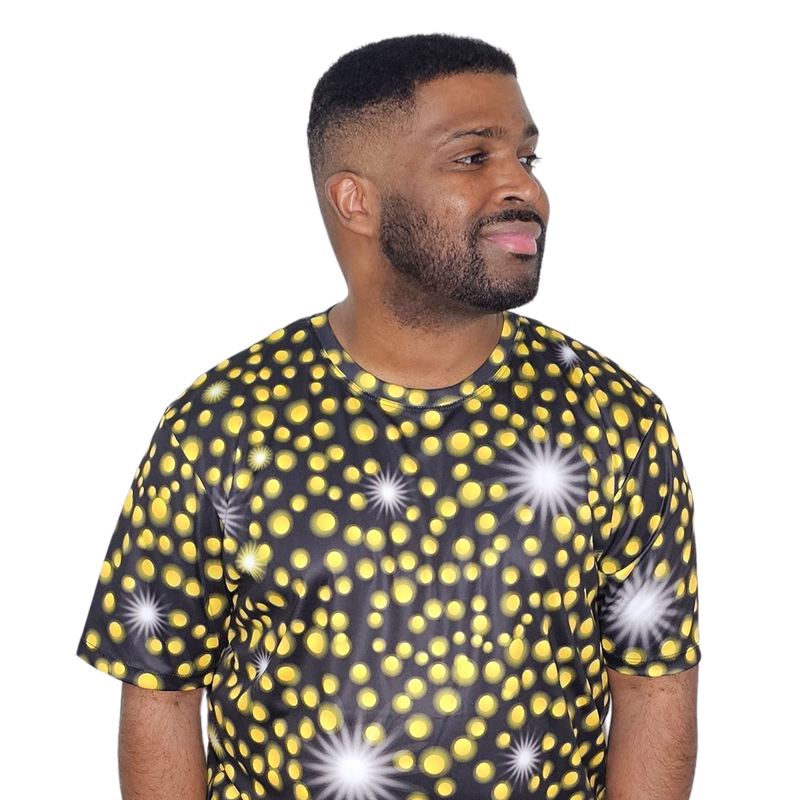 Model shown in side profile, wearing a sports jersey featuring an all over scattered light and firefly glow pattern in yel...