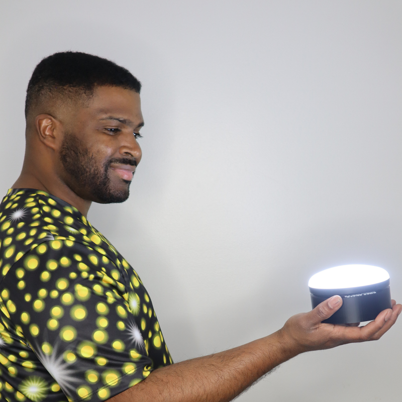 Model shown from a three quarter angle, wearing a sports jersey featuring an all over scattered light and firefly glow pat...