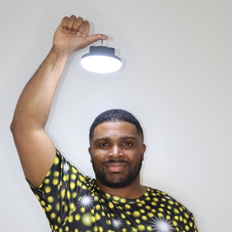 Model shown with arms crossed, wearing a sports jersey featuring an all over scattered light and firefly glow pattern in y...