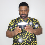 Model shown with hand on hip, wearing a sports jersey featuring an all over scattered light and firefly glow pattern in ye...
