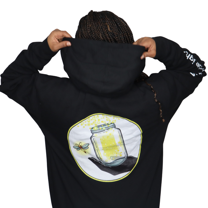 Model shown with arms crossed, wearing a black zip hoodie featuring The Light Providers logo patch on the chest and We Bri...