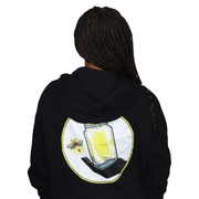 Model shown with hand on hip, wearing a black zip hoodie featuring The Light Providers logo patch on the chest and We Brin...