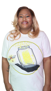 Model shown with hand on hip, wearing a garment dyed t-shirt featuring The Light Providers logo and firefly jar graphic in...