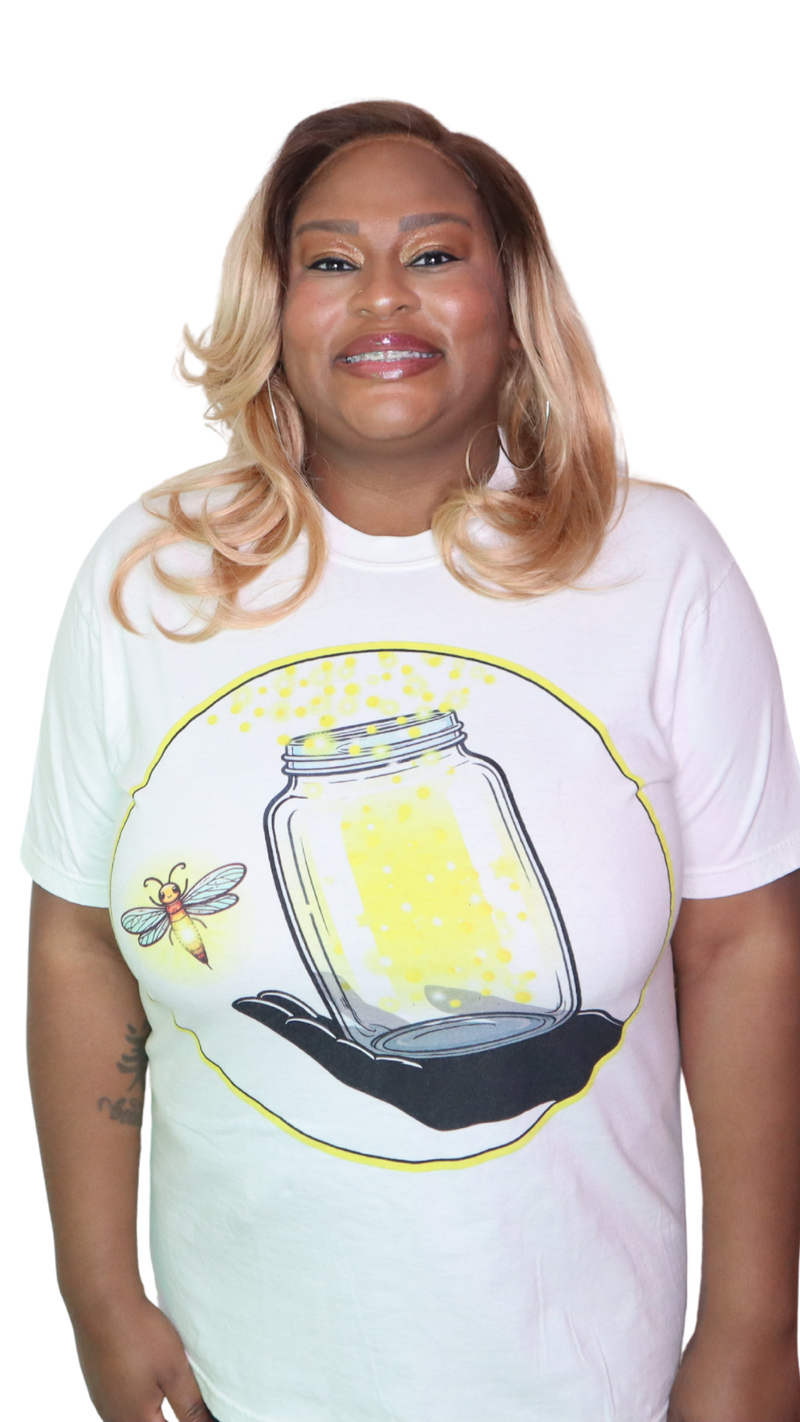 Model shown with hand on hip, wearing a garment dyed t-shirt featuring The Light Providers logo and firefly jar graphic in...