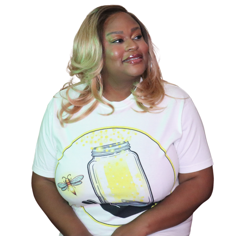 Model shown from the front, wearing a garment dyed t-shirt featuring The Light Providers logo and firefly jar graphic in w...