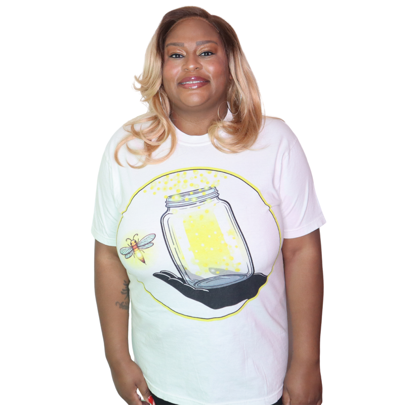 Model shown in side profile, wearing a garment dyed t-shirt featuring The Light Providers logo and firefly jar graphic in ...