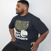 Model shown from the front, wearing a garment dyed t-shirt featuring a scattered firefly light pattern above The Light Pro...