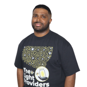 Model shown in a detail view of the print, wearing a garment dyed t-shirt featuring a scattered firefly light pattern abov...