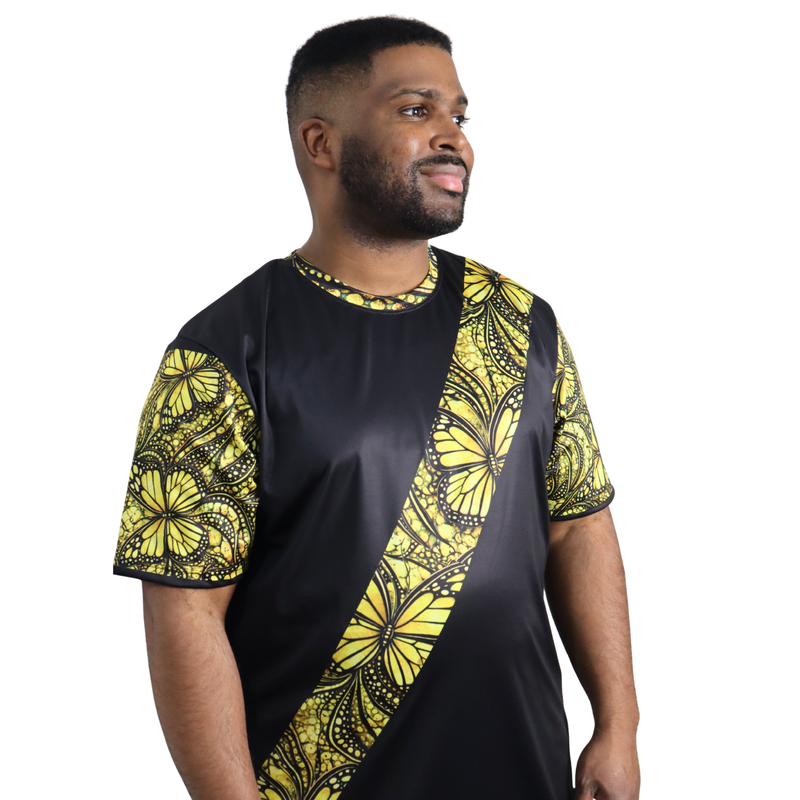 Person wearing a t-shirt featuring a yellow monarch butterfly Ankara style print sash across a black tee
