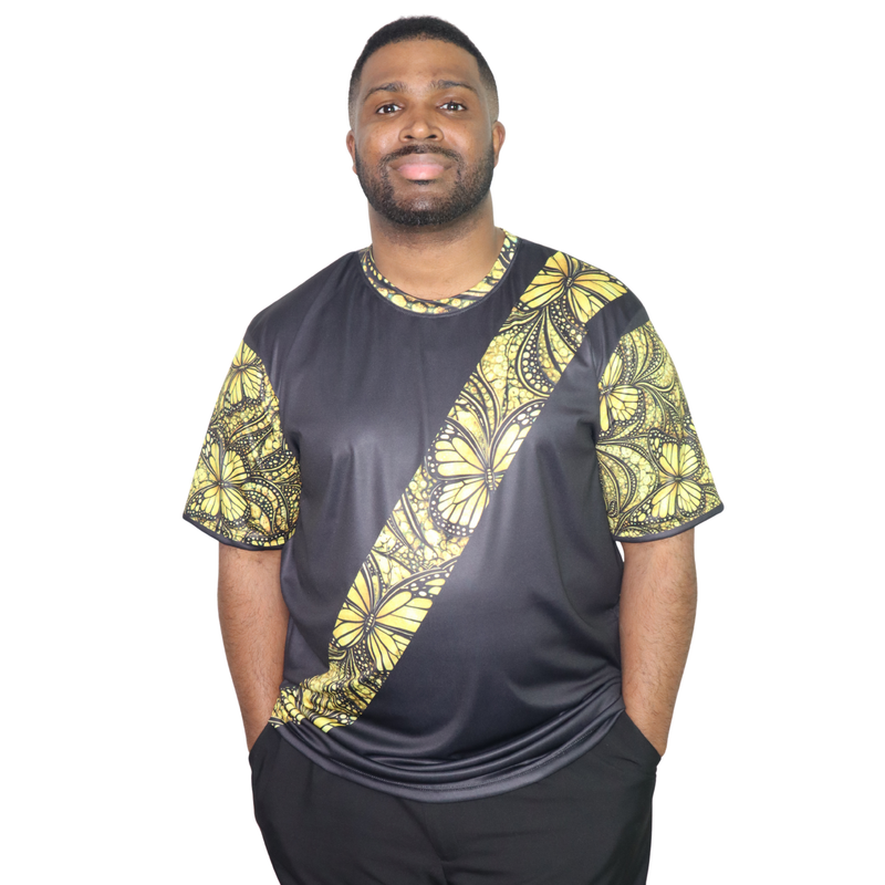 Model shown close up, wearing a t-shirt featuring a yellow monarch butterfly Ankara style print sash across a black tee