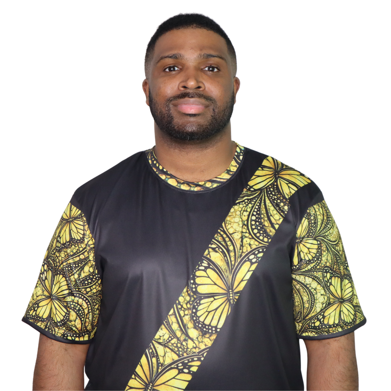 Model shown with arms crossed, wearing a t-shirt featuring a yellow monarch butterfly Ankara style print sash across a bla...