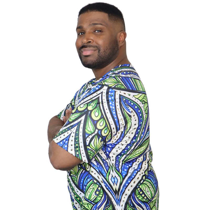 Person wearing a t-shirt featuring an all over green white and blue Ankara style leaf pattern