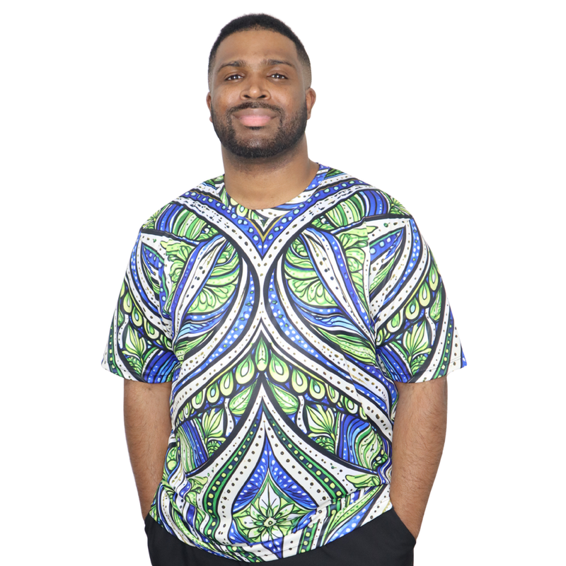 Model shown close up, wearing a t-shirt featuring an all over green white and blue Ankara style leaf pattern