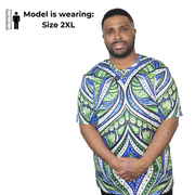 Model shown from a three quarter angle, wearing a t-shirt featuring an all over green white and blue Ankara style leaf pat...