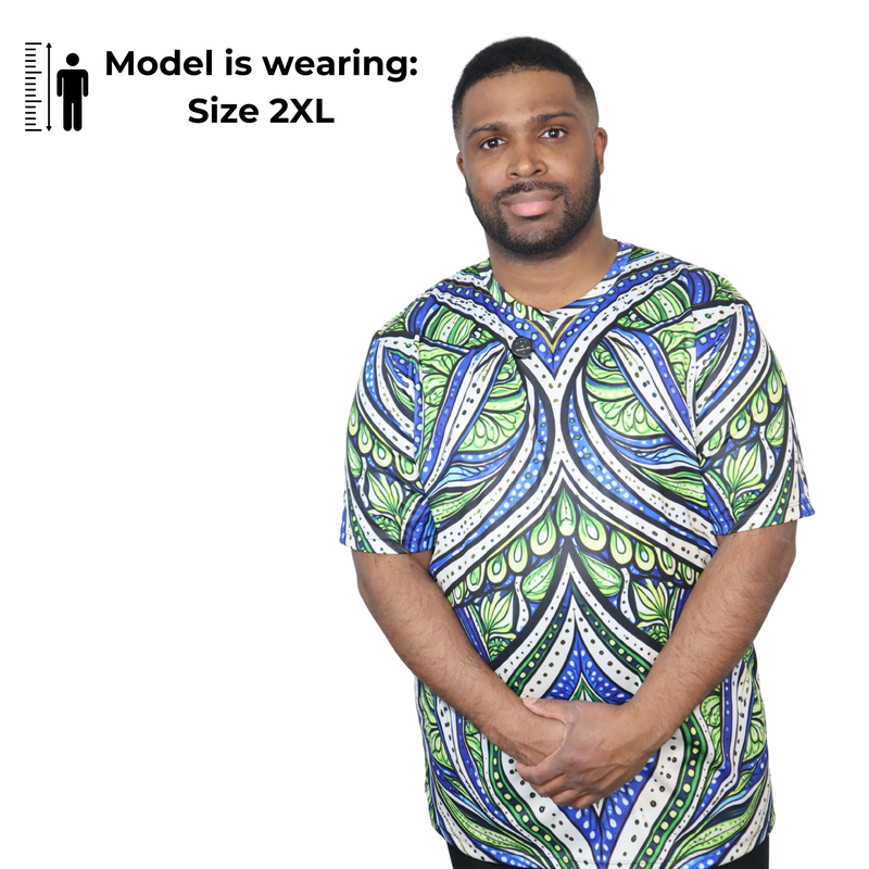 Model shown from a three quarter angle, wearing a t-shirt featuring an all over green white and blue Ankara style leaf pat...