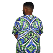 Model shown looking to the side, wearing a t-shirt featuring an all over green white and blue Ankara style leaf pattern