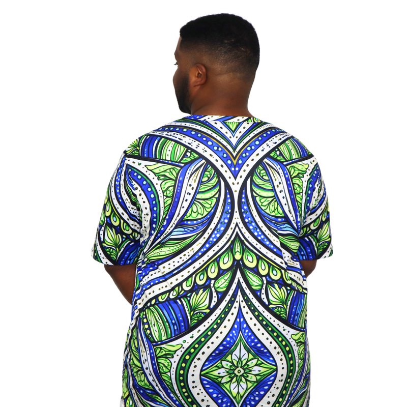 Model shown looking to the side, wearing a t-shirt featuring an all over green white and blue Ankara style leaf pattern