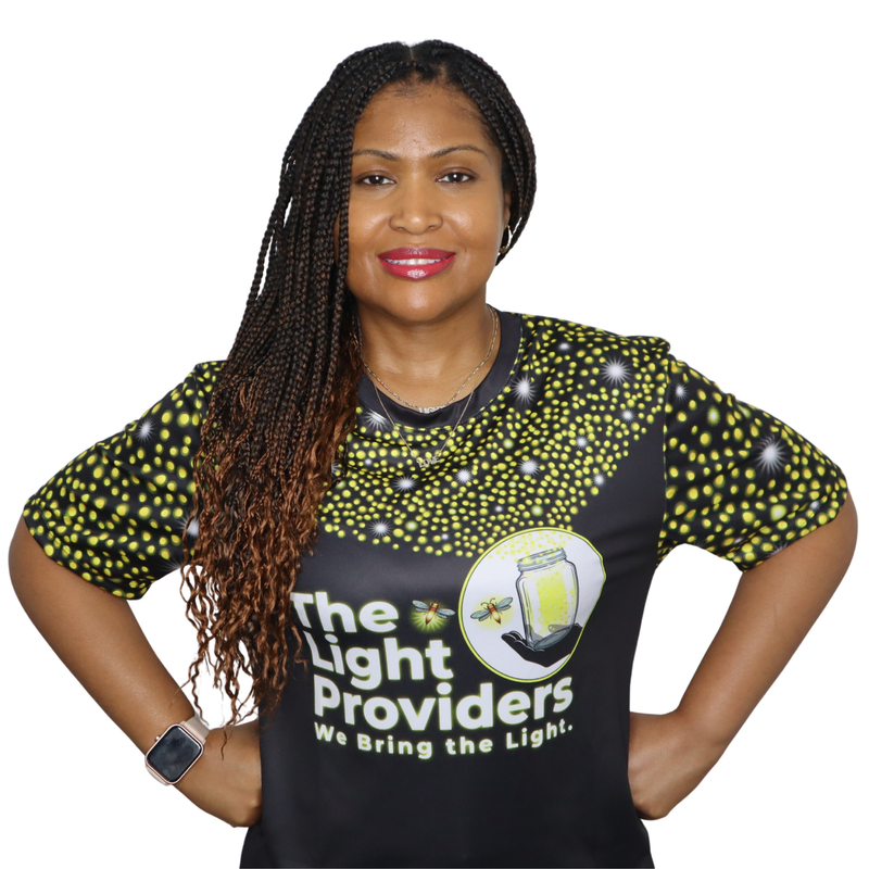Person wearing a sports jersey featuring a scattered firefly light pattern with The Light Providers logo and firefly jar g...