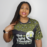 Model shown with arms crossed, wearing a sports jersey featuring a scattered firefly light pattern with The Light Provider...