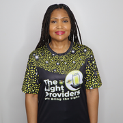 Model shown with hand on hip, wearing a sports jersey featuring a scattered firefly light pattern with The Light Providers...