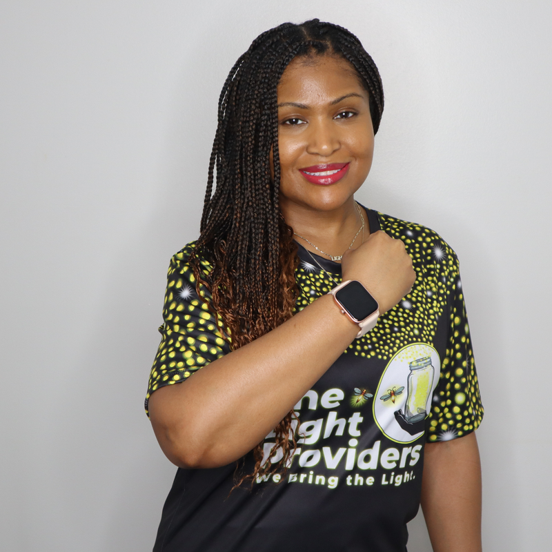 Model shown from a three quarter angle, wearing a sports jersey featuring a scattered firefly light pattern with The Light...