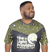 Model shown with hand on hip, wearing a sports jersey featuring a scattered firefly light pattern with The Light Providers...