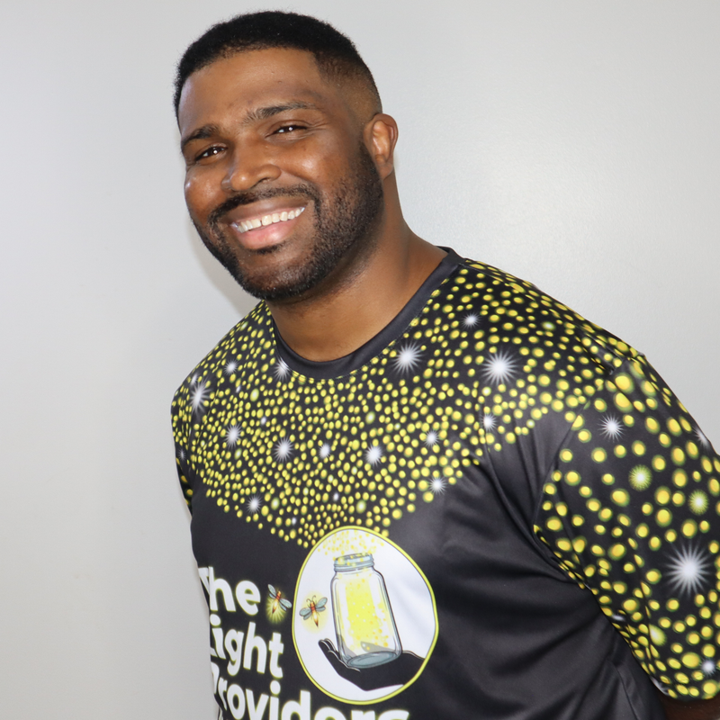 sports jersey shown flat, front view featuring a scattered firefly light pattern with The Light Providers logo and firefly...