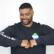 Model shown from the front, wearing a black crewneck sweatshirt featuring a Sierra Leone text and country outline map prin...
