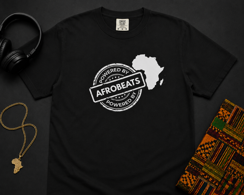 Powered By Afrobeats stamp design with a white Africa map silhouette on a black t-shirt, styled product photo