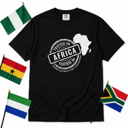 Tested In Africa stamp design with a white Africa map silhouette on a black t-shirt, styled product photo