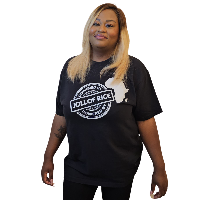 with arms crossed, Powered By Jollof Rice stamp design with a white Africa map silhouette on a black t-shirt