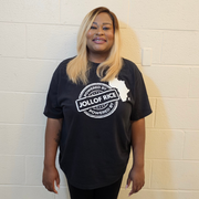 with hand on hip, Powered By Jollof Rice stamp design with a white Africa map silhouette on a black t-shirt