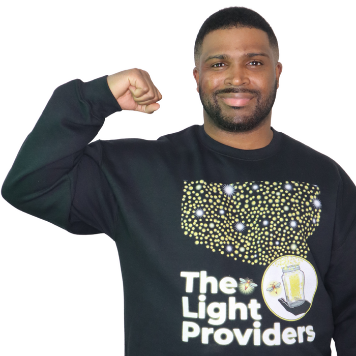 Man wearing a black sweatshirt with 'The Light Providers' logo on a white background