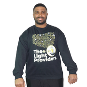 Man wearing a black sweatshirt with 'The Light Providers' logo on a white background
