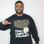 Man wearing a black sweatshirt with 'The Light Providers' logo on a white background