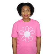 Woman wearing a pink t-shirt with a white flower design on a white background