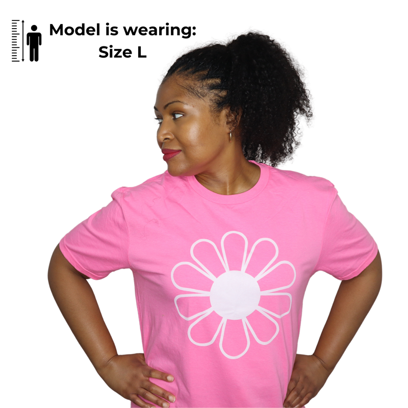 Model wearing a pink t-shirt with a white flower design on a white background