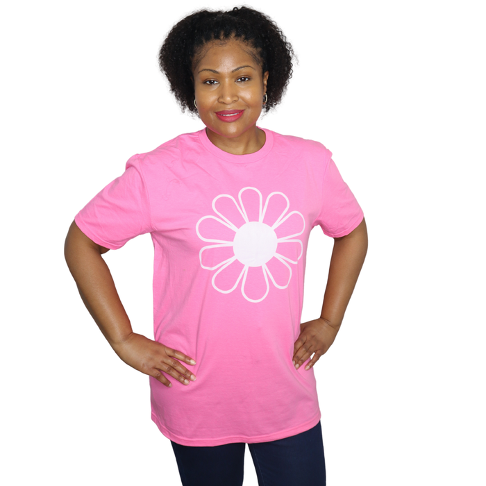 Person wearing a pink t-shirt with a white flower design on a white background