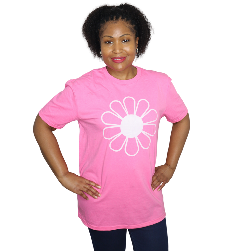 Person wearing a pink t-shirt with a white flower design on a white background