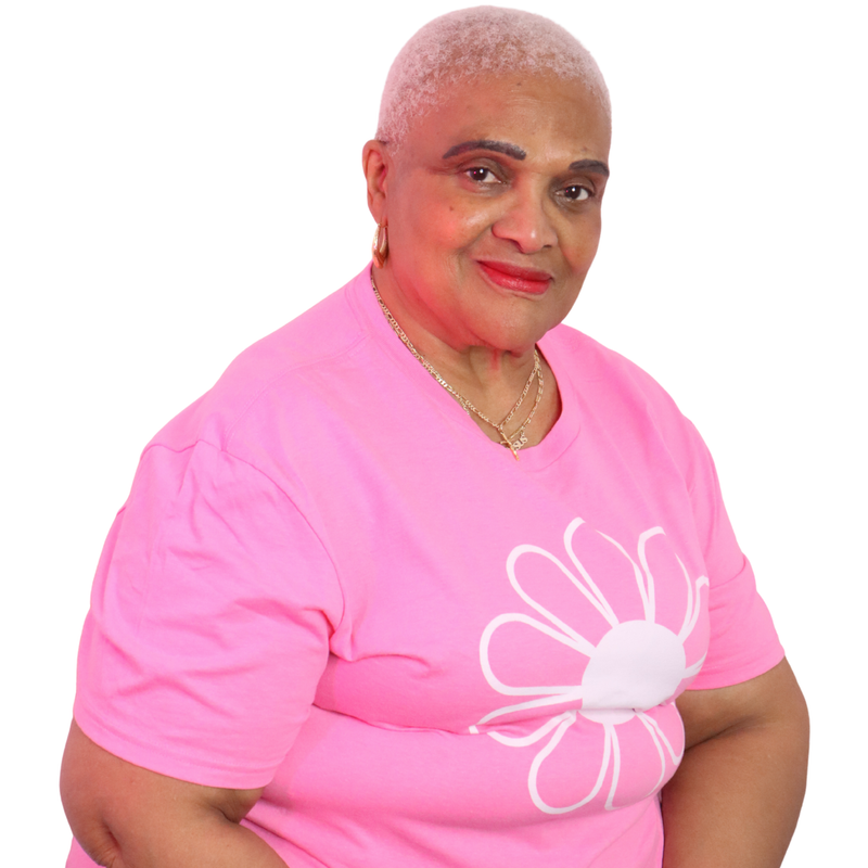 Woman wearing a pink shirt with a white flower design on a white background