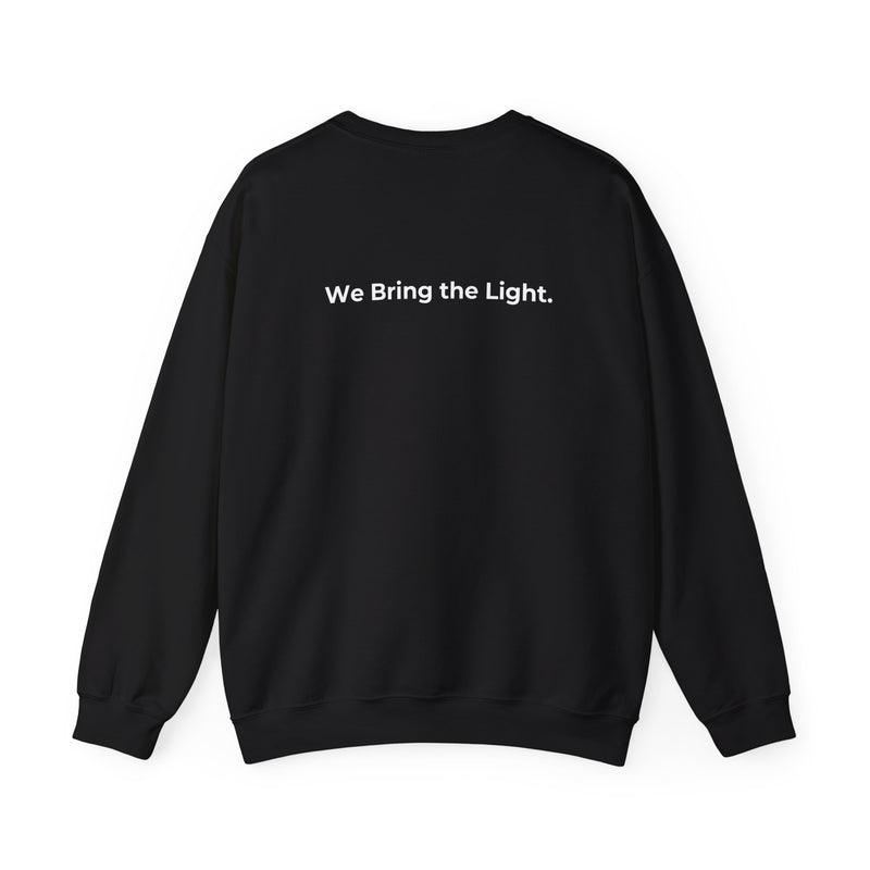 Black sweatshirt with 'We Bring the Light' text on the back against a white background