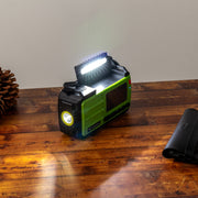 Survival Pro Emergency Radio - in use on a brown table with top light open