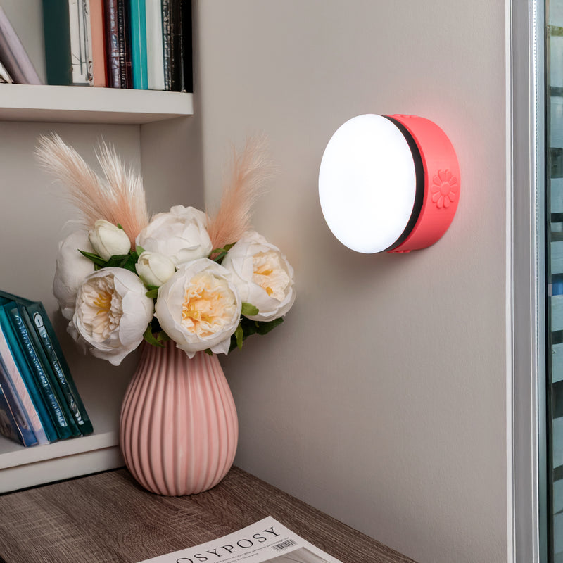 Pink flower wall mount showcased on a wall by a desk