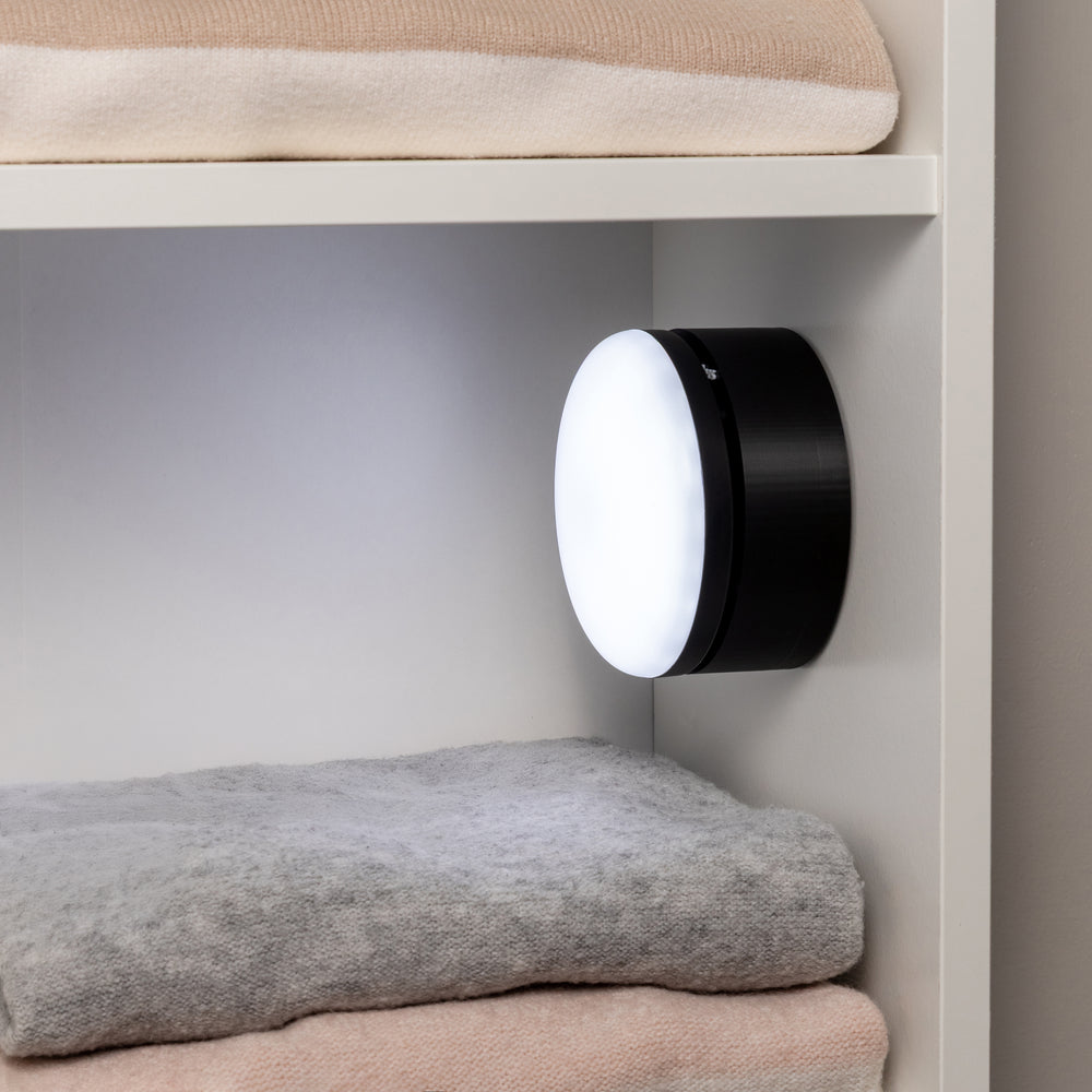 Black mount in use with a wireless light in a closet