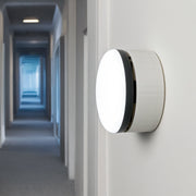 White wall mount showcased on a wall in a hallway