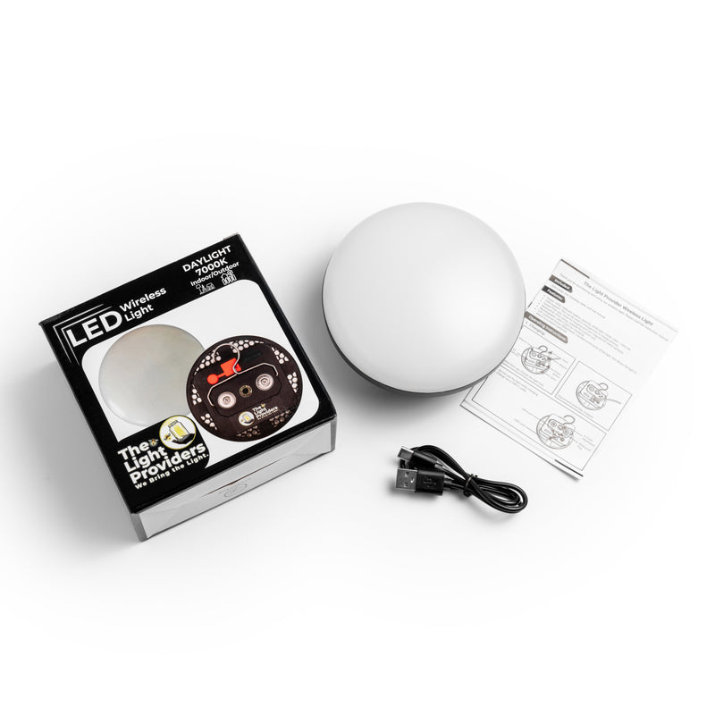LED wireless light with packaging, cable, and user manual on a white background